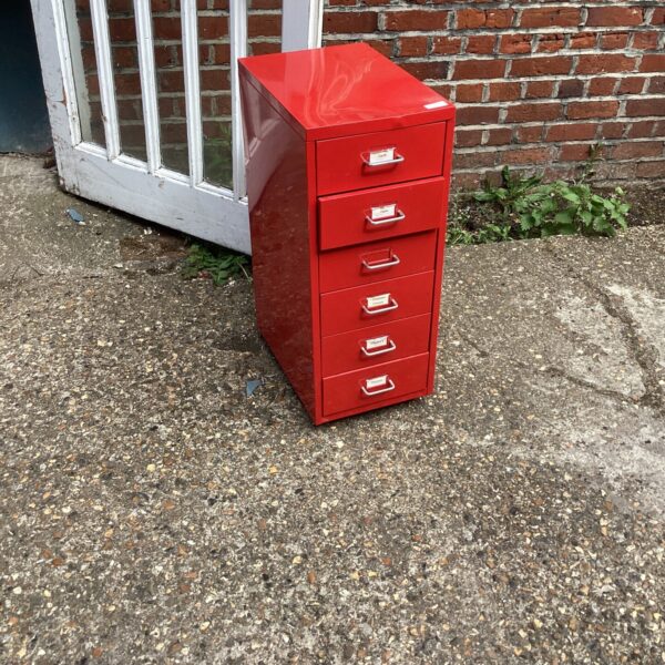 Vintage red metal drawers for storage and organisation.