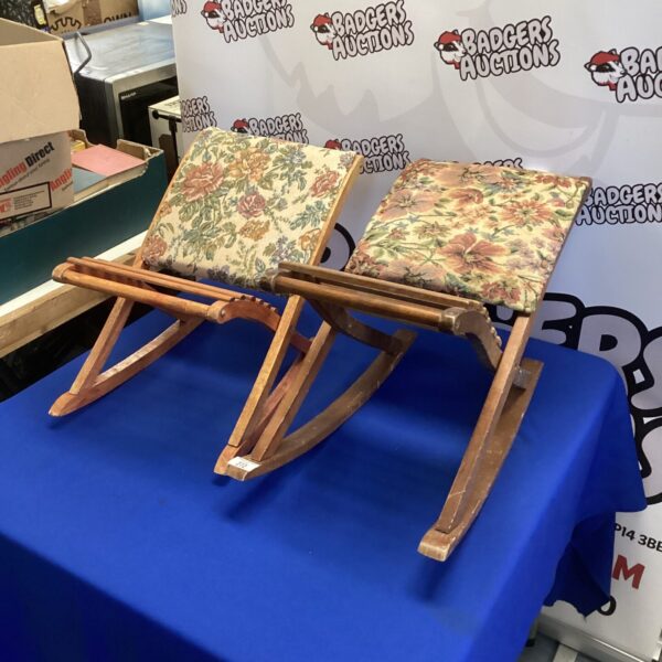Pair of vintage rocking footstools with floral upholstery.