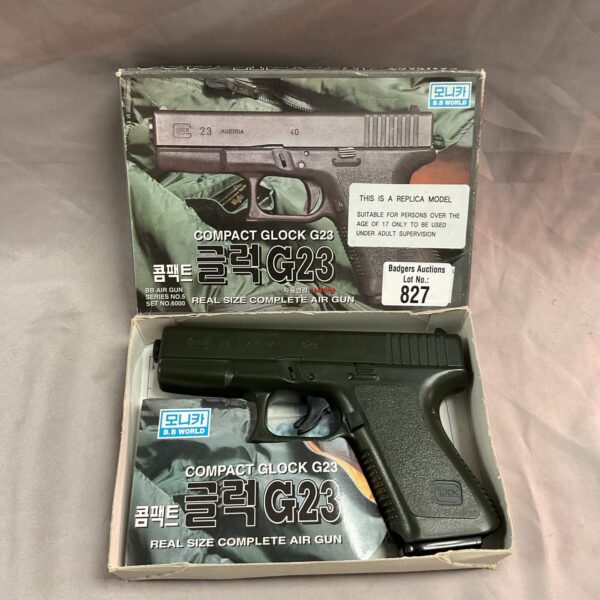Airsoft Glock G23 replica pistol in box.