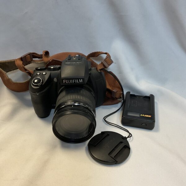 Fujifilm HS30 EXR digital camera with lens and charger.
