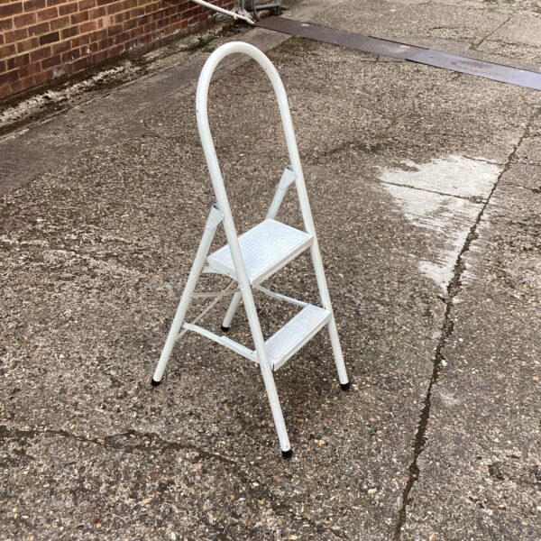 Vintage metal kitchen steps folded for storage.