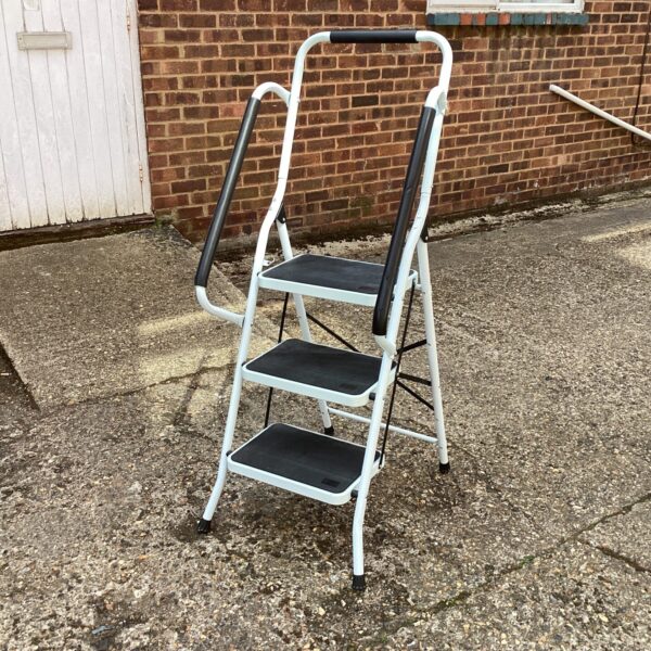 White aluminium kitchen steps, folded and ready for use.