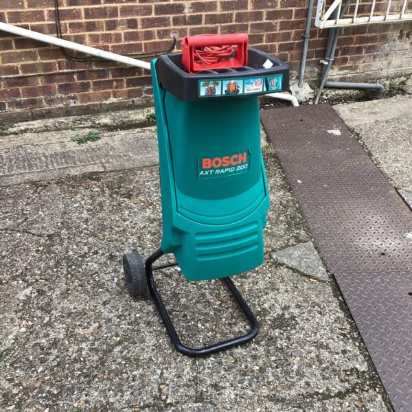 Green Bosch AXT Rapid 2600 garden shredder for garden waste.