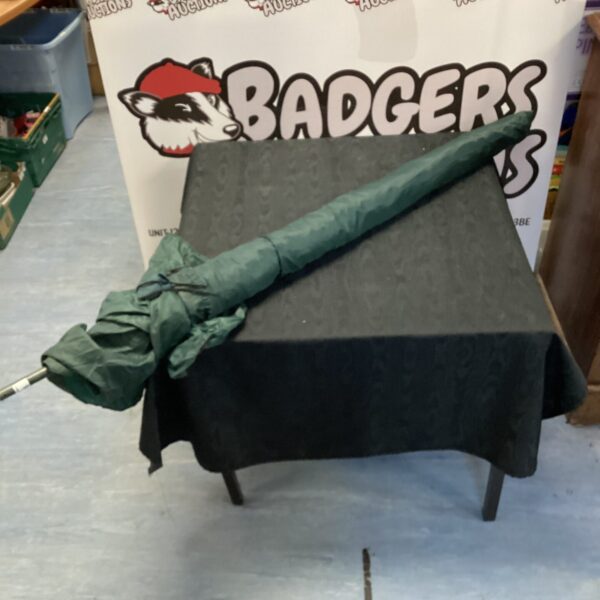 Dark green fishing umbrella with tie-down feature for anglers.