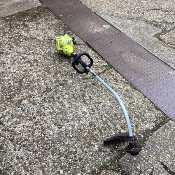 Ryobi petrol strimmer showing side view and engine housing.