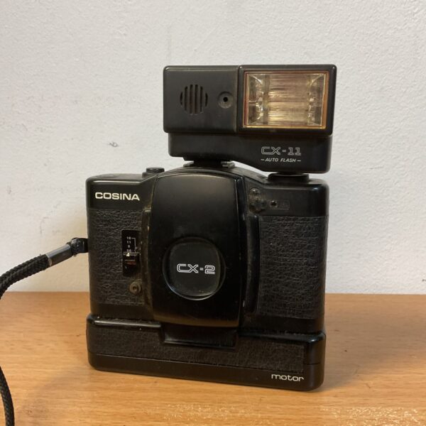 Vintage Cosina CX-2 camera with CX-11 flash unit for film photography.
