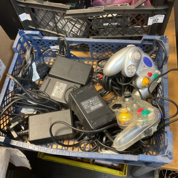 Nintendo Gamecube power supplies and controllers in a tray.