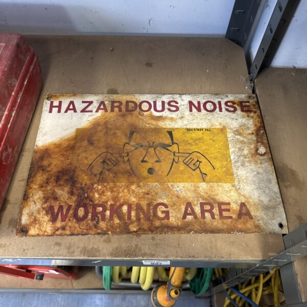 Vintage hazardous noise sign with warning graphic.