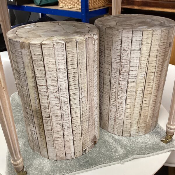 Pair of rustic driftwood stools for coastal home decor.