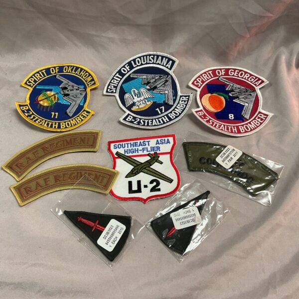 Collection of vintage Air Force cloth patches with squadron insignia.