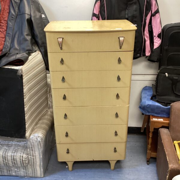 Vintage mid century blonde oak chest of drawers with seven drawers.