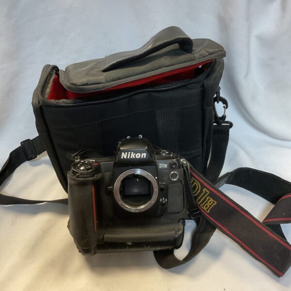 Nikon D1H digital SLR camera with bag, professional photography equipment.