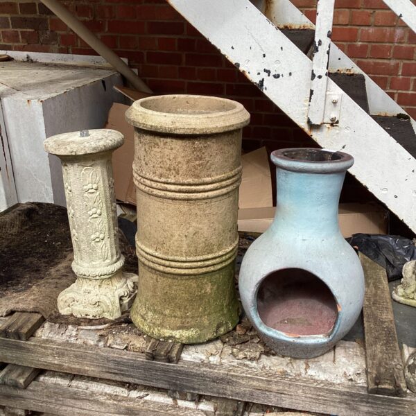 Lot of three vintage garden chimney pots in weathered terracotta.
