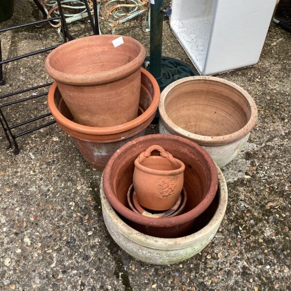 Collection of vintage terracotta pots for garden plants.