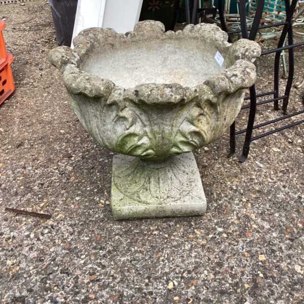 Weathered stone garden planter for outdoor display.