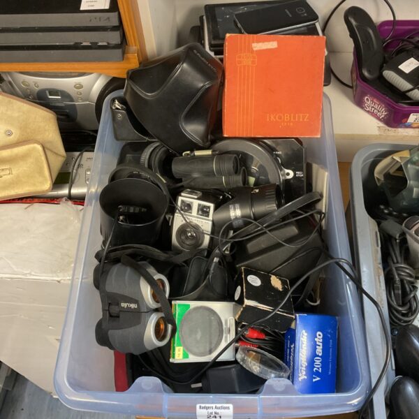 Vintage camera lot with a Kodak camera and photography accessories.