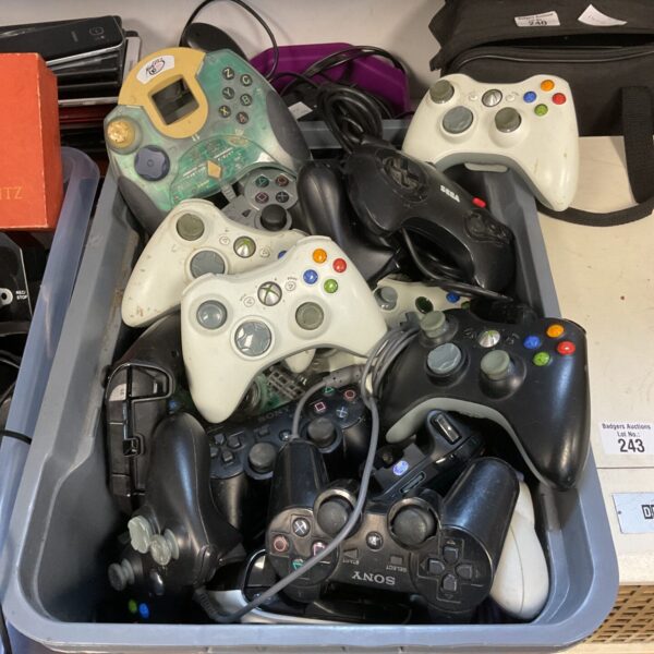 Mixed lot of gaming controllers including Xbox, PlayStation and Sega.