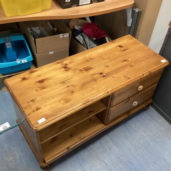 Vintage pine media cabinet for storing entertainment equipment.