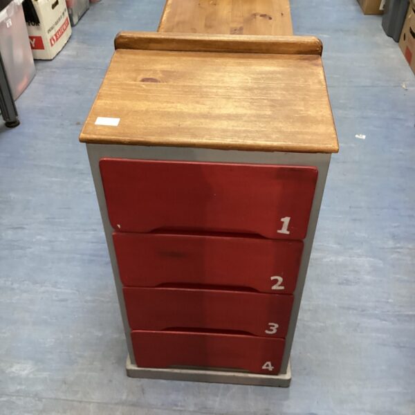 Front view of a hand-painted numbered drawer unit.
