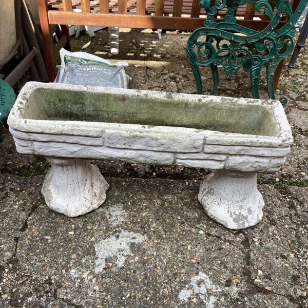 Weathered stone garden planter for outdoor plants and garden decor.