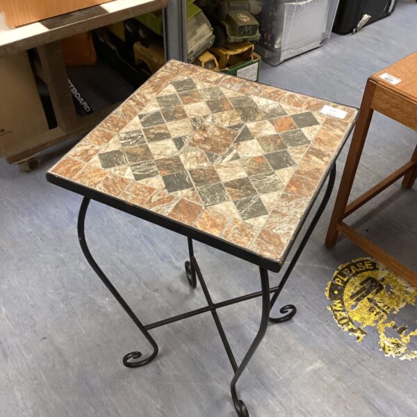 Colourful mosaic tile garden table with wrought iron base.