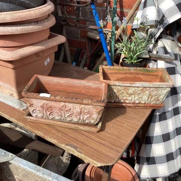 Two vintage terracotta garden window box planters with raised detailing.