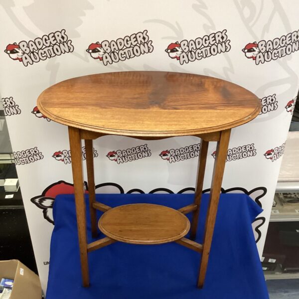 Vintage elm oval occasional table with curved legs.