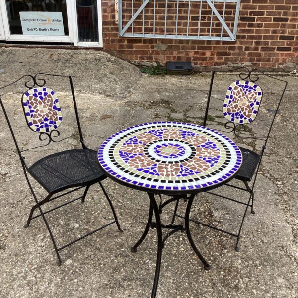 Colourful mosaic tile top garden set with two chairs.