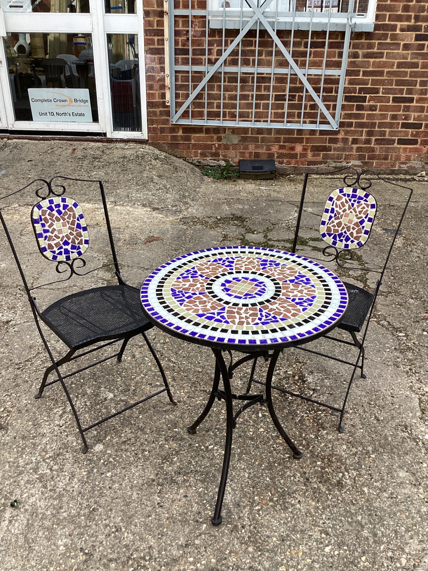 1094 Tile topped garden table and two chairs