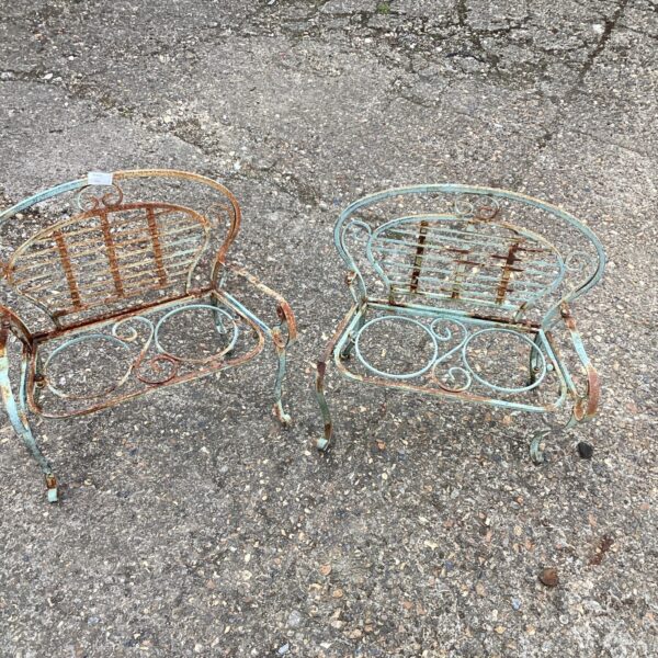 Pair of vintage metal garden plant pot benches with rust.