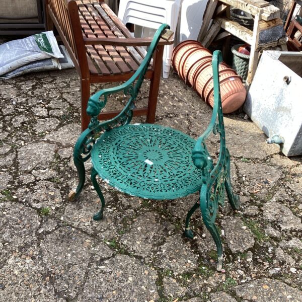 Vintage metal garden table and bench set with floral detailing.
