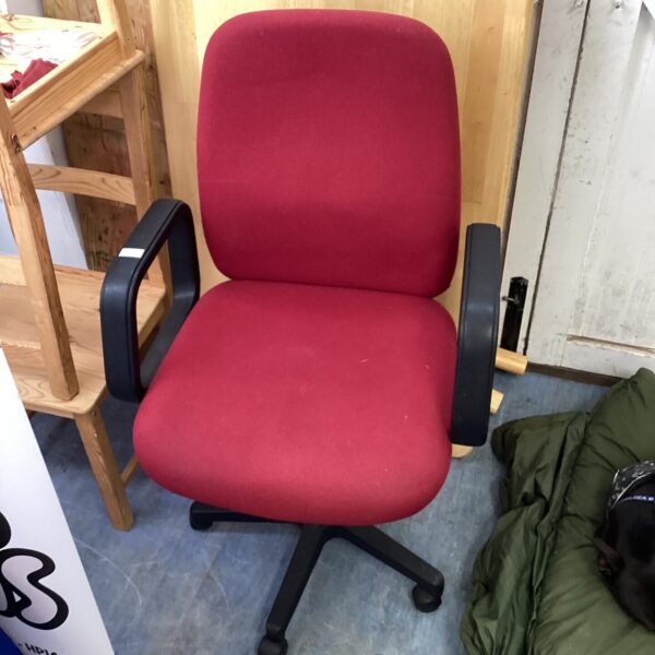 Red office swivel chair with five-star base and castors.