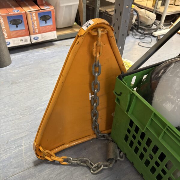 Yellow wheel clamp with chain for vehicle security.