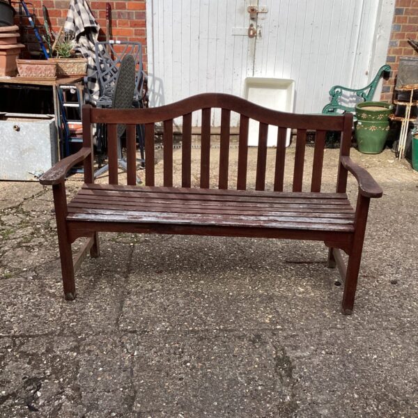 Rustic wooden garden bench in a garden setting.