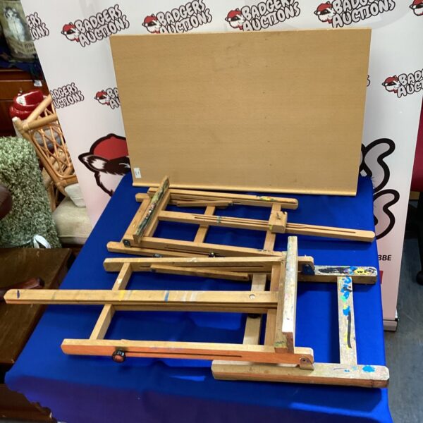 Three wooden artist easels for painting and display.