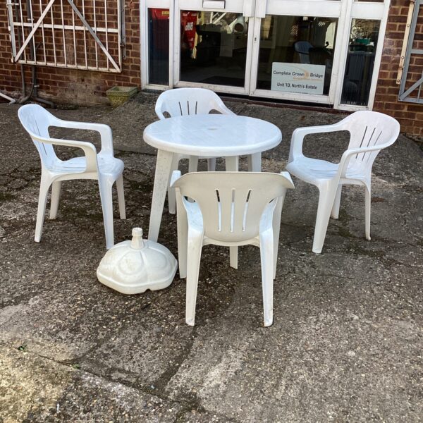 White plastic garden furniture set with table and chairs.