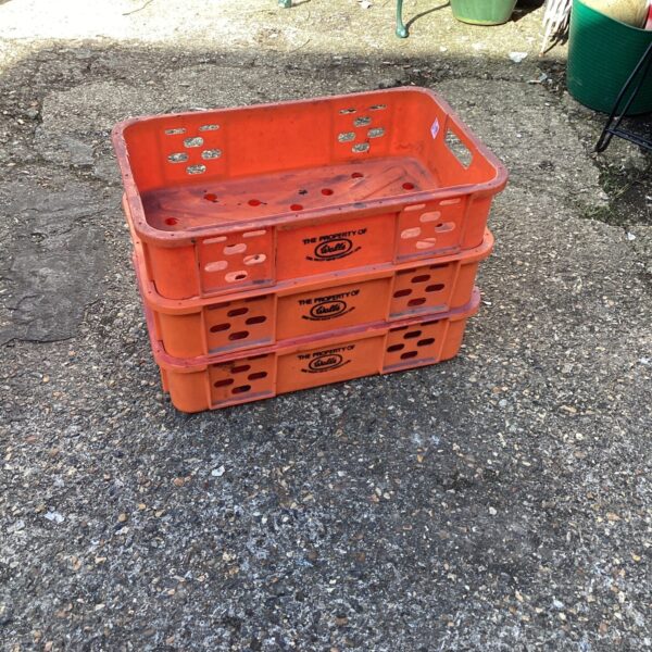 Vintage Three Walls plastic storage trays stacked outdoors.