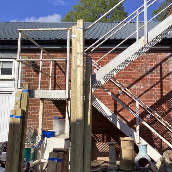 Bundles of timber stored outdoors, ready for construction projects.