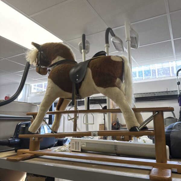 Vintage children’s rocking horse with faux leather saddle.