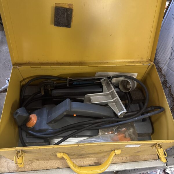 Vintage electric wood planer in yellow carry case.