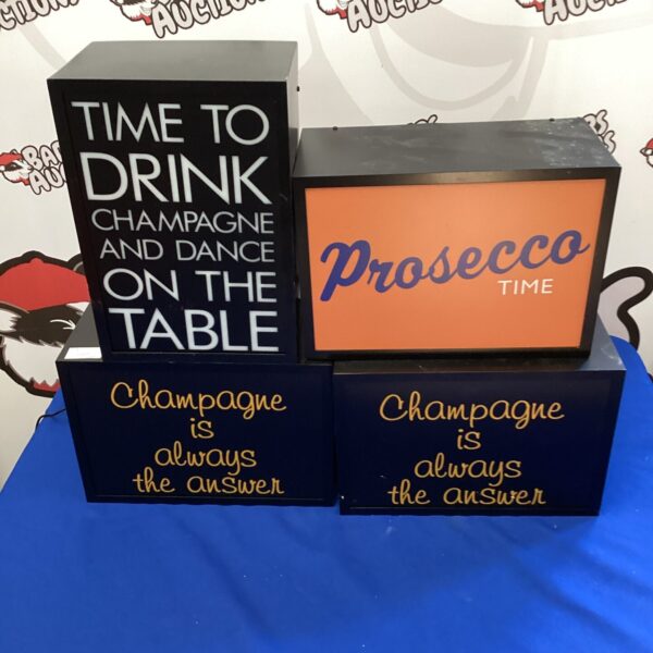 Lot of four illuminated champagne and prosecco signs for home bar decor.