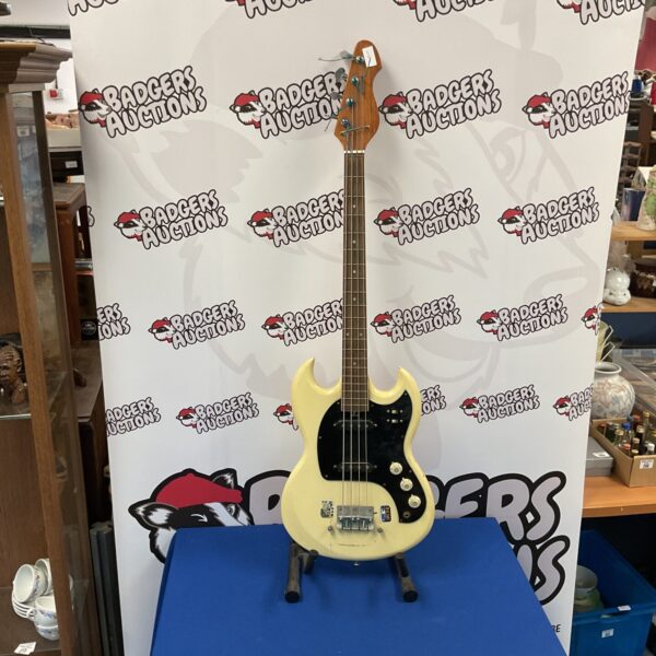 Vintage white bass guitar from the 1970s, side view.