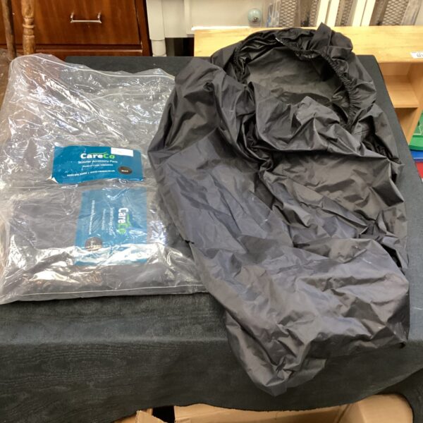 Two used mobility scooter covers for outdoor protection.