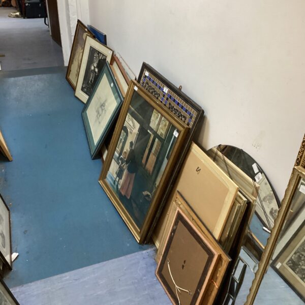Lot of vintage framed artworks and paintings on display.