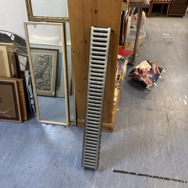 Metal drainage gulley for garden or pathway drainage.