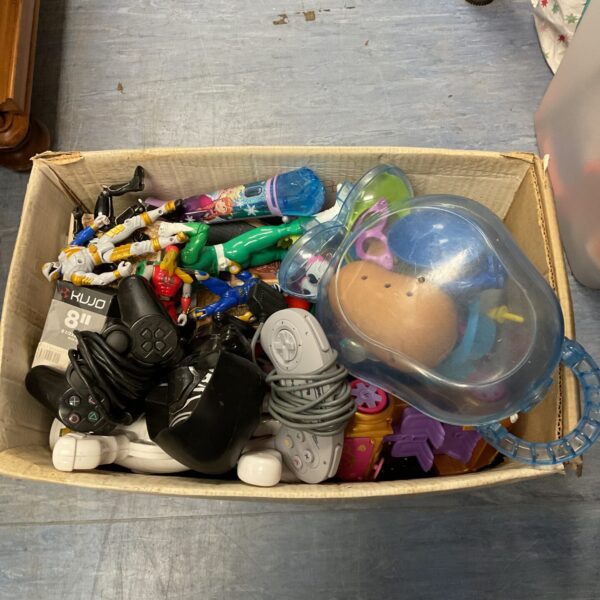 Mixed toy lot with gaming controllers and action figures.