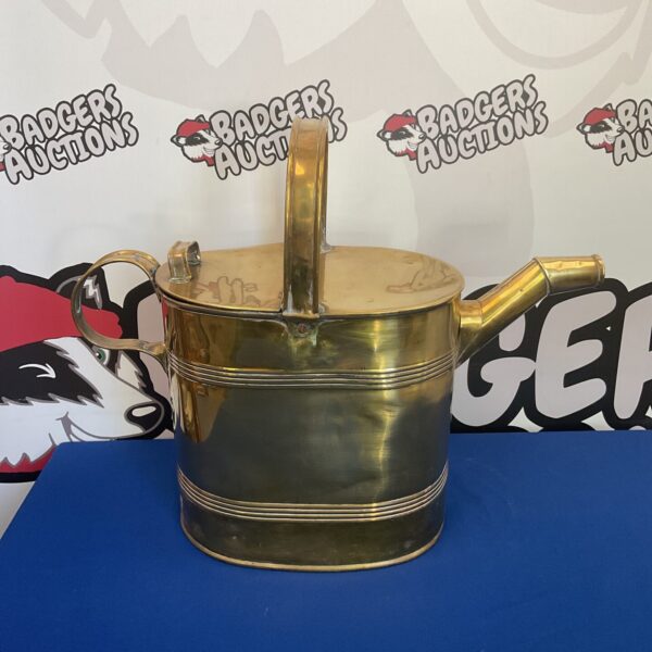 Large vintage brass watering can with aged patina.