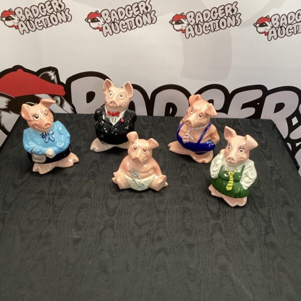 Set of four vintage Natwest piggy banks in various professions.