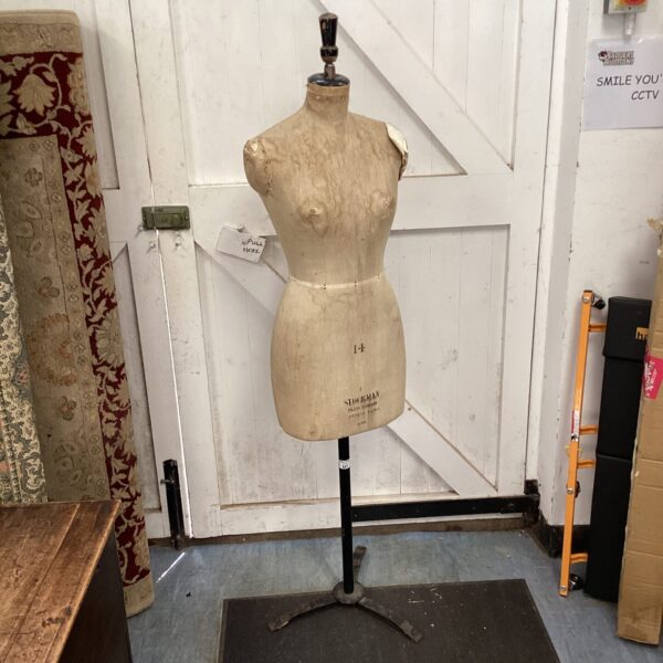 Vintage Stockman dress form mannequin in a workshop setting.
