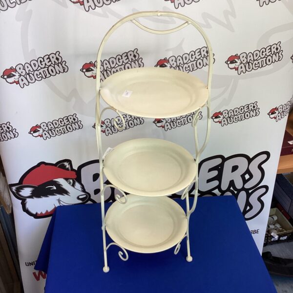 White metal three-tier cake stand for displaying desserts and treats.
